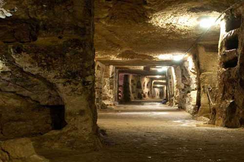 A subterranean view of Rome during our Catacombs tour. Descend into subterranean, learn about the struggle of the first christian communities in Rome.